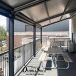 Attico fixed motorized awning with durable aluminum frame and high-quality vinyl fabric, designed for commercial outdoor spaces.